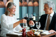 Mature couple celebrating at restaurant