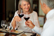 Elderly woman having dinner with her husband at restaurant