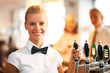 Beautiful young bartender smiling at work