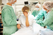 Surgeons comforting depressed patient before surgery