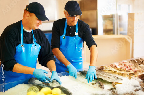 Photo: Fishmongers arranging seafood Fishmongers arranging seafood