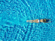 Top view of young woman swimming underwater