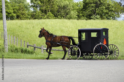 Photo: Amish (mennonite) people riding their buggy Amish (mennonite) people riding their buggy