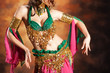 Photo: Beautiful exotic belly dancer woman a rot-green costume Beautiful exotic belly dancer woman a rot-green costume
