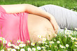 Beautiful pregnant woman laying on grass Beautiful pregnant woman laying on grass