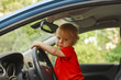 Baby at driver seat with steering wheel