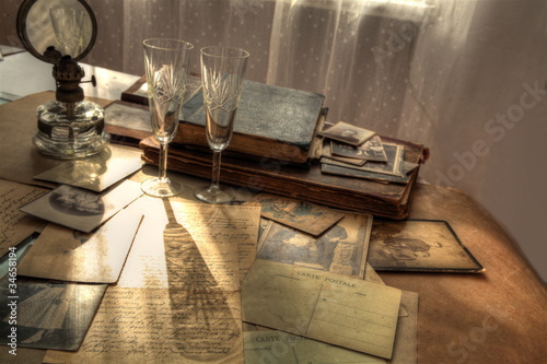 Photo: Old photos,letters,books,glasses and lamp. Old photos,letters,books,glasses and lamp.