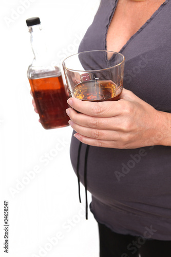 Photo: Pregnant Woman With a Glass of Whiskey Pregnant Woman With a Glass of Whiskey