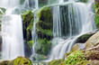 Waterfall with trees and rocks in mountain