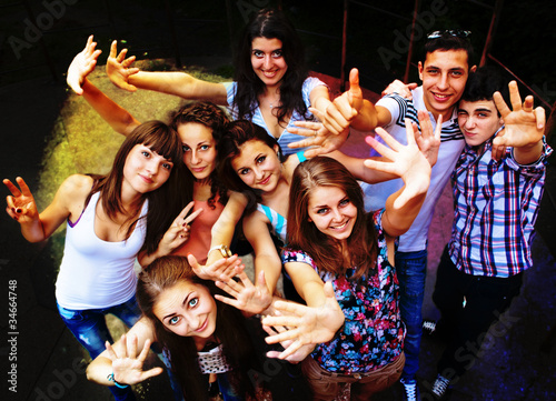 Photo: A group of young people dancing at a disco. A group of young people dancing at a disco.