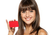 Close-up portrait of young smiling female holding credit card