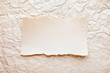 ripped piece of paper on old crushed paper background. vintage r ripped piece of paper on old crushed paper background. vintage r