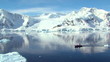 small boat travels through antarctic ocean