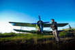 Pilot in front of vintage plane