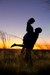 Photo: Couple on the sunset background. Couple on the sunset background.