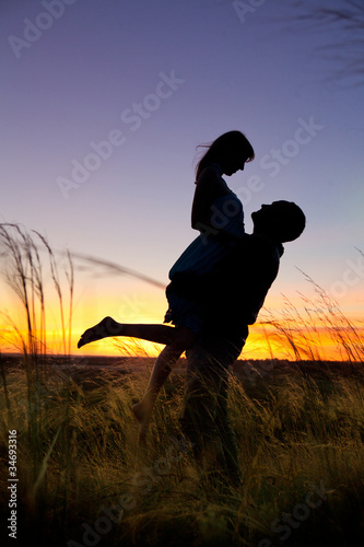 Photo: Couple on the sunset background. Couple on the sunset background.