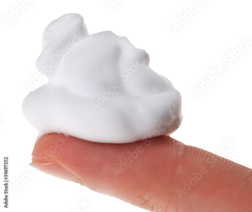 Photo: Shave foam (cream) sample on index finger, isolated on white Shave foam (cream) sample on index finger, isolated on white