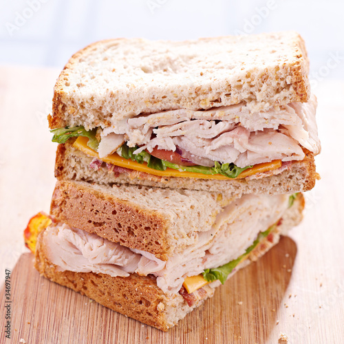 Photo: a turkey club sandwhich cut in halves with selective focus a turkey club sandwhich cut in halves with selective focus