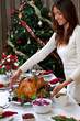 Christmas roasted turkey in young beautiful woman hands Christmas roasted turkey in young beautiful woman hands