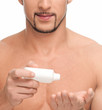 Foto: Young man applying cream. Cosmetic Young man applying cream. Cosmetic