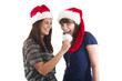 Foto: Zwei Frauen mit Weihnachtsmütze Zwei Frauen mit Weihnachtsmütze