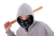 A teen with a stick, in a act of juvenile delinquency