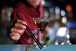 cocktail with bartender at background