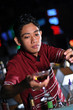 bartender making cocktail at nightclub bar