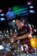 bartender making cocktail at nightclub bar