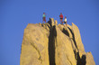 Team of climbers reaching the summit.