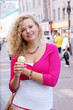 Blonde woman with ice cream in the street close up