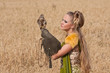 The woman in a beautiful old style dress with falcon The woman in a beautiful old style dress with falcon