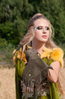 The woman in a beautiful old style dress with falcon The woman in a beautiful old style dress with falcon