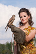 The woman in a beautiful old style dress with falcon The woman in a beautiful old style dress with falcon