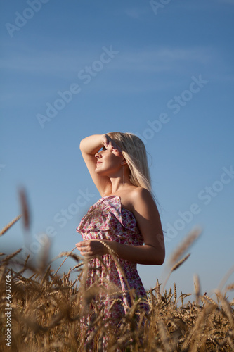 Photo: The beautiful girl in the field with wheat The beautiful girl in the field with wheat