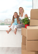 Happy woman and little girl in a new home - moving theme