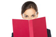 Close-up portrait of female peeking over the book