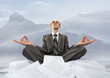 Businessman meditating in mountains