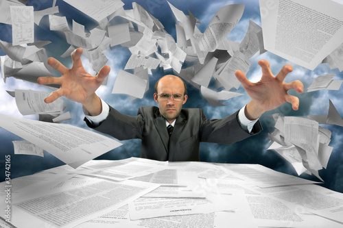Photo: Serious businessman manipulating papers Serious businessman manipulating papers