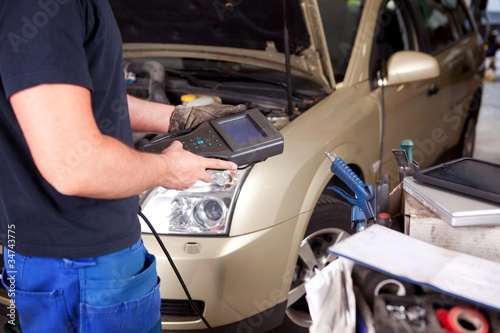 Photo: Mechanic with Diagnostic Equipment Mechanic with Diagnostic Equipment