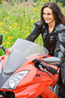 portrait of young beautiful woman driving motorcycle
