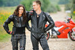 two young people against motorbike two young people against motorbike