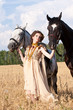 The woman hold two horses The woman hold two horses