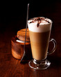 latte mug on a wooden table with a spoon and sugar