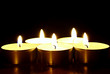 a row of votives with short depth of field