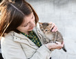 Young girl hugging a small kitten