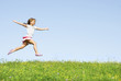 little girl jumping on meadow, she playing