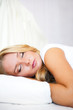 Portrait of young beautiful sleeping woman on bed at bedroom