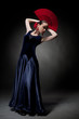 young woman dancing flamenco on black