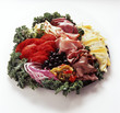 Antipasti garnished with kale, onions and tomatoes